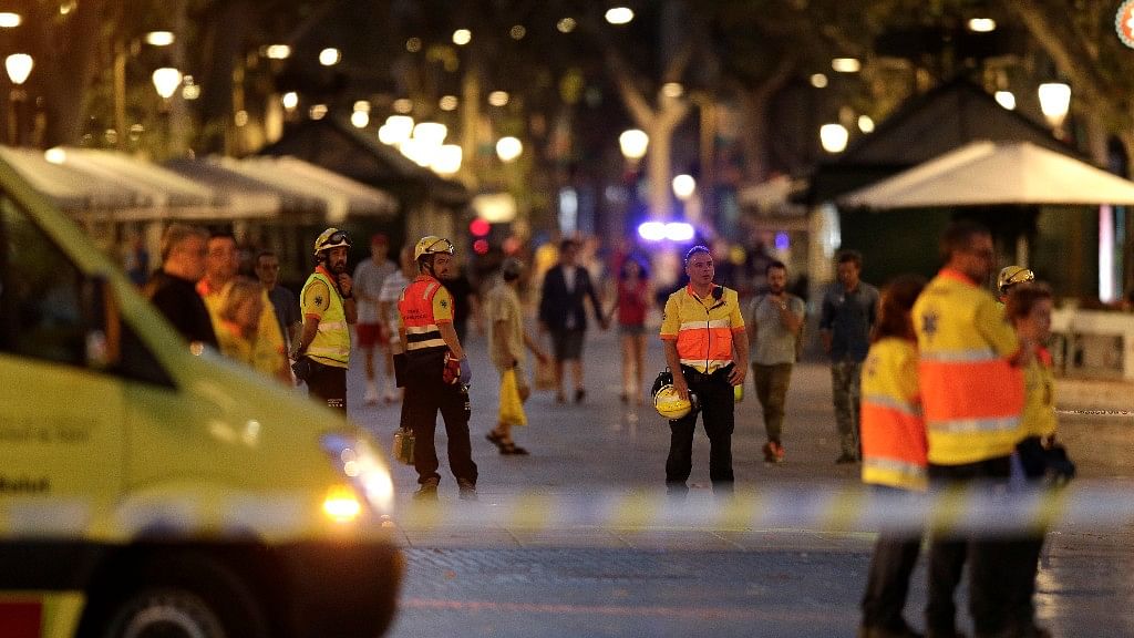 Emergency workers stand on a blocked street in Barcelona, Spain.