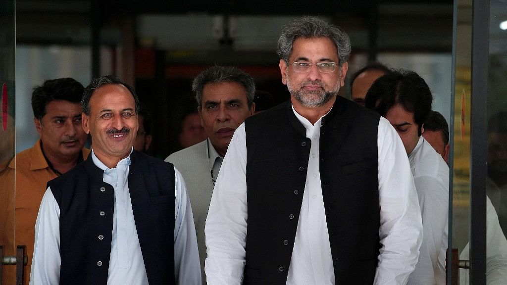 Pakistan’s premier-designate Shahid Khaqan Abbasi, right, leaves with his aids after meeting with politicians in Parliament house in Islamabad, Pakistan