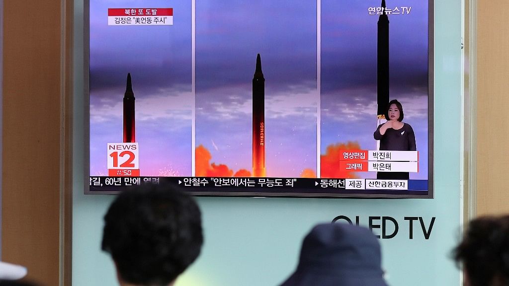 People watch a TV screen showing a local news program reporting about North Korea’s missile launch at Seoul Train Station in  South Korea on 30 August 2017.