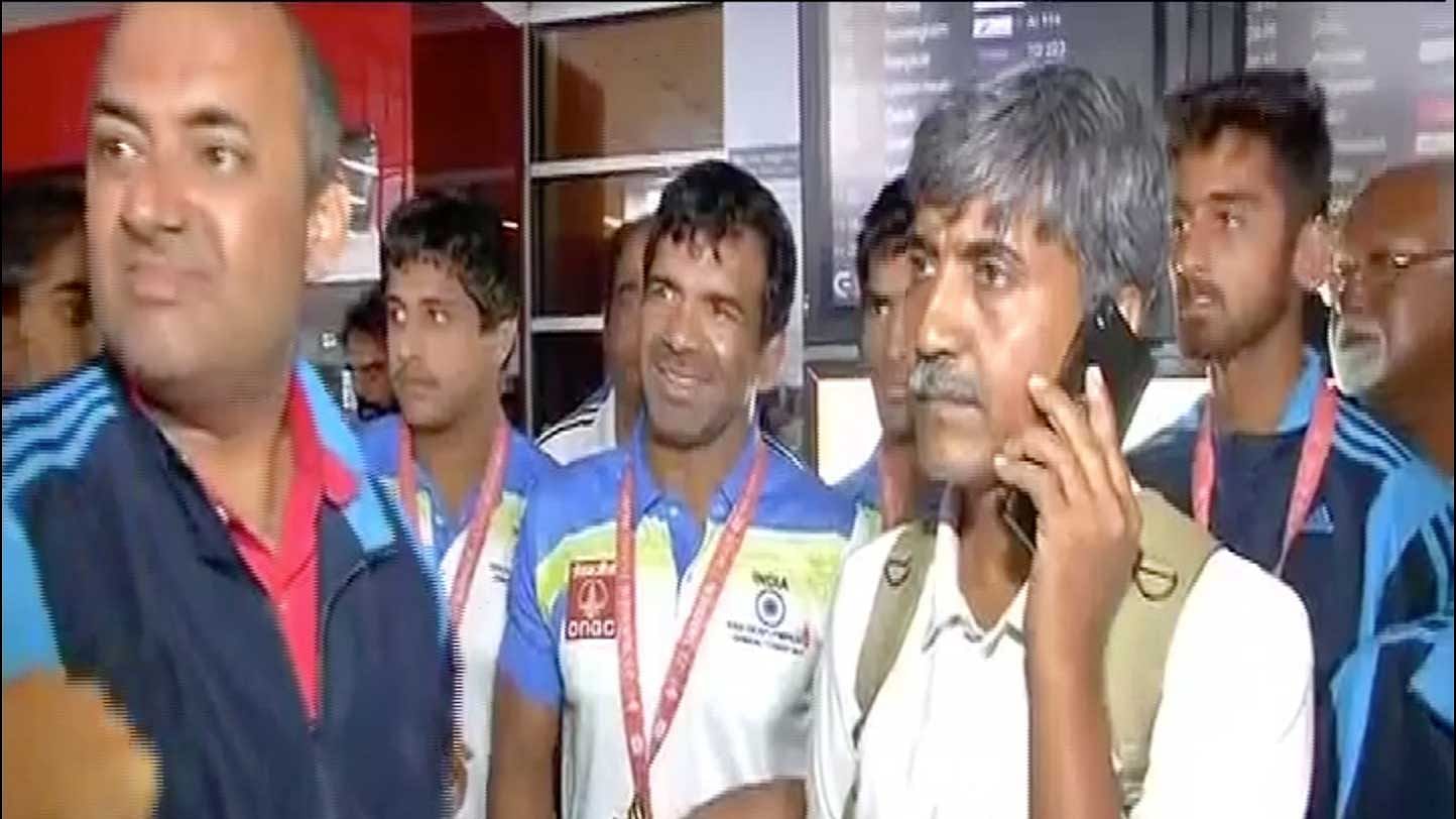 Gold medal-winning wrestler Virender Singh was all smiles at the airport, even though the sports ministry sent no welcome party for the contingent