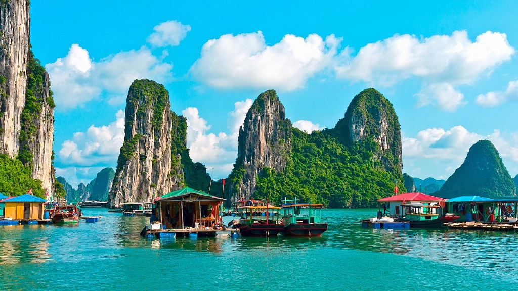 Floating village near rock islands in Halong Bay. 