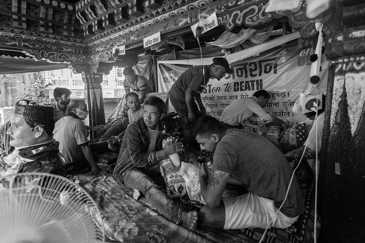 Gorkhaland supporters help three Activists of GJM’s youth wing, the Yuva Morcha, sitting inside a sheltered house observing fast-unto-death.
