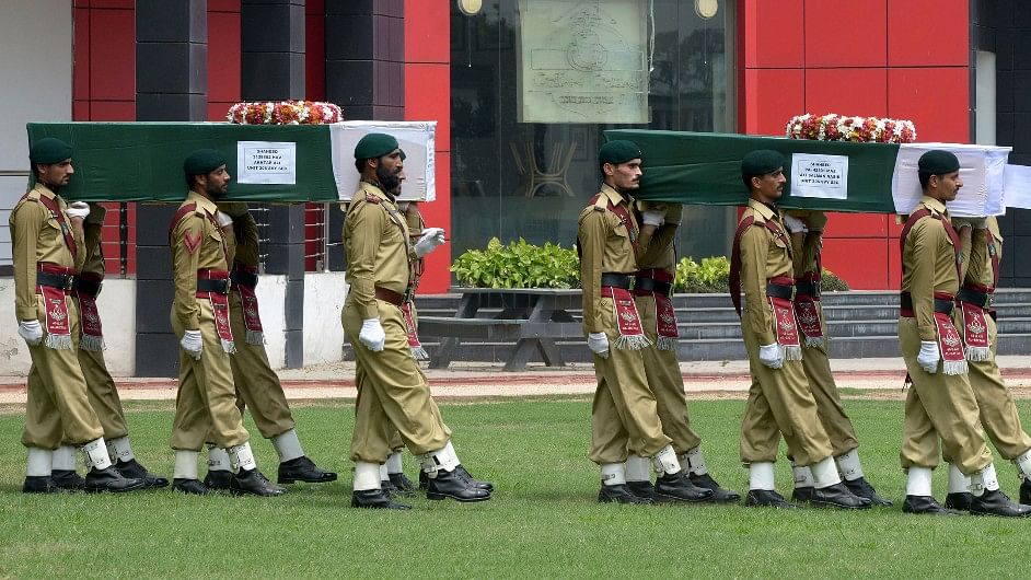 Pakistan Army carrying the coffins of the deceased soldiers. (Photo: Muhammad Sajjad/AP)