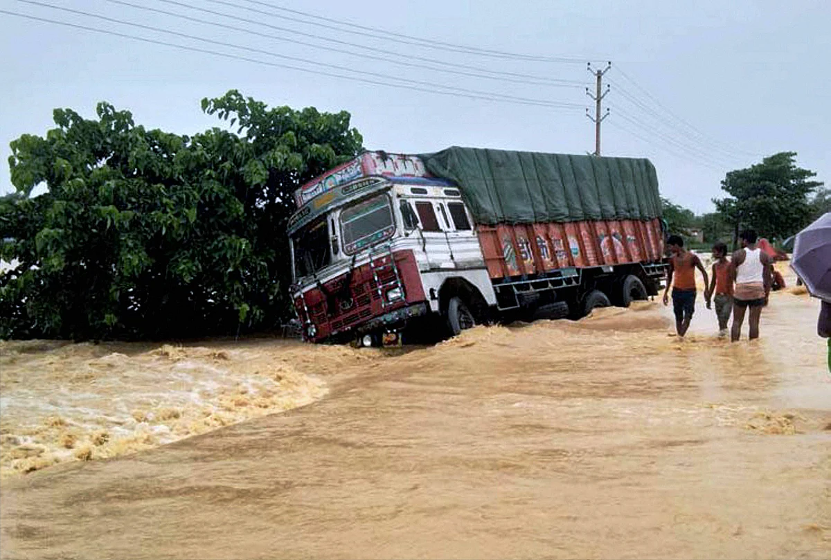 A truck drifts off the submerged NH 28 at flooded Ramgadhwa in East Champaran, Bihar.