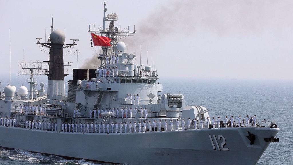 File photo of Chinese servicemen gesturing from the deck of a naval vessel.