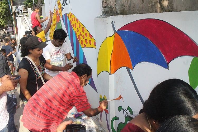 Armed with paint brushes, volunteers unleashed their creativity on a drab looking wall. 