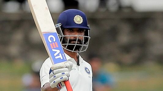 Ajinkya Rahane raises his bat after scoring a half-century during the second Test against Sri Lanka in Colombo on Thursday.
