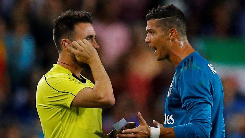 Cristiano Ronaldo speaks with referee Ricardo de Burgos Bengoetxea after being shown a red card during the Spanish Super Cup first leg against Barcelona on Sunday.