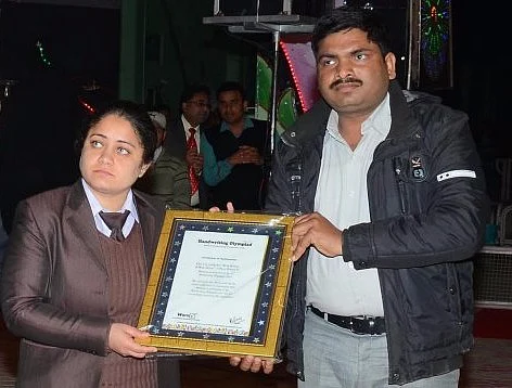 Vipasana Insan handing a certificate to a Dera member.