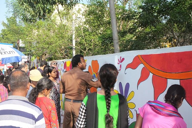 Armed with paint brushes, volunteers unleashed their creativity on a drab looking wall. 
