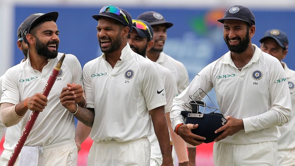 Virat Kohli and Shikhar Dhawan share a laugh at the end of the third Test against Sri Lanka.