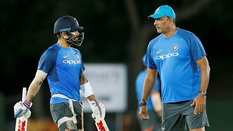 India’s captain Virat Kohli speaks to coach Ravi Shastri during a training session.