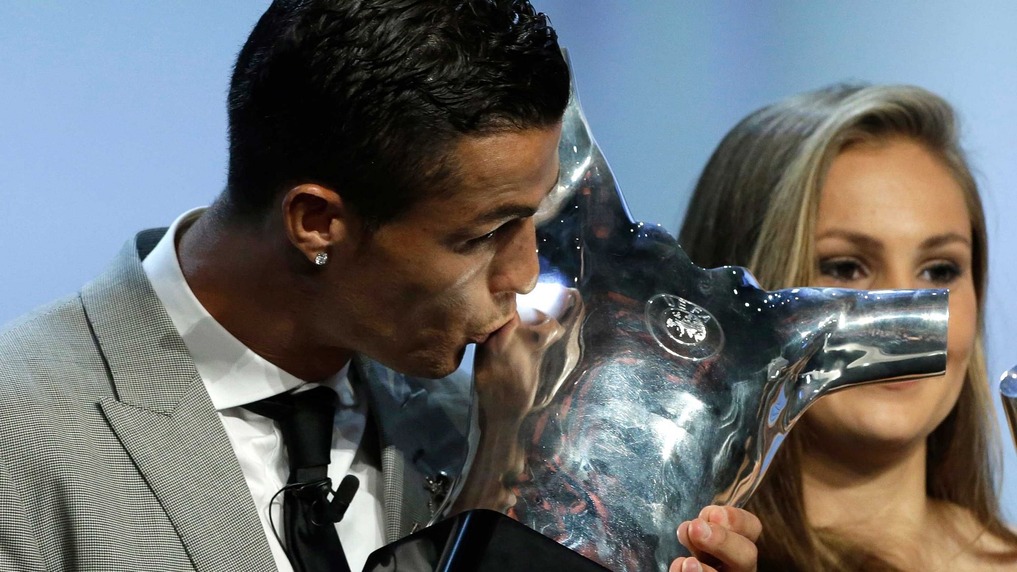 Madrid’s forward Cristiano Ronaldo of Portugal, kisses his “best player of the year” trophy during the UEFA Champions League draw at the Grimaldi Forum, in Monaco<a></a>