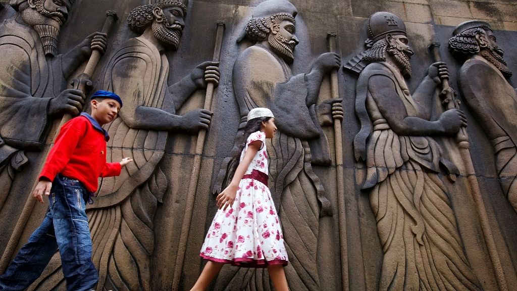 Parsi children touch the walls of a Parsi fire temple in Mumbai.