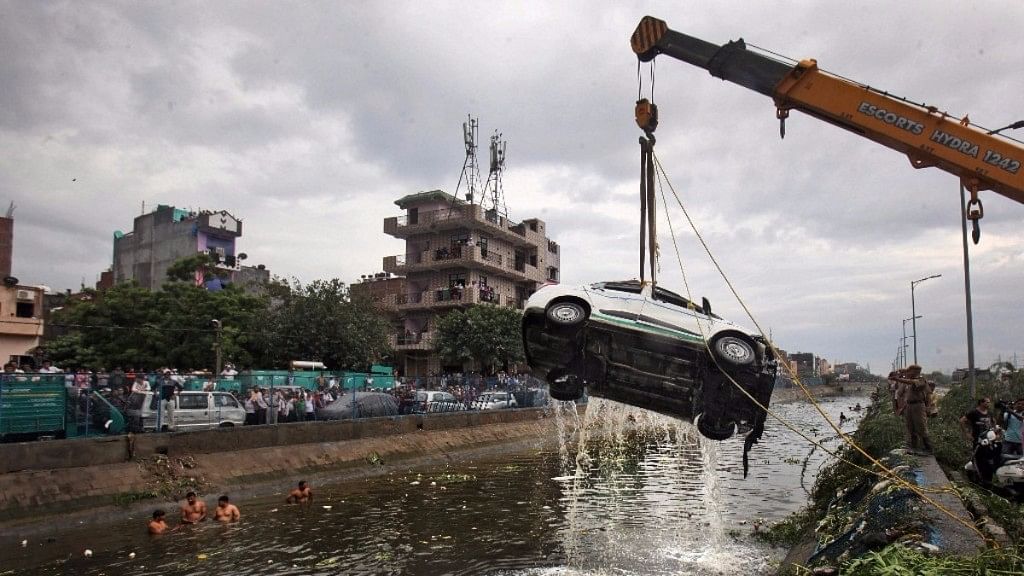 A car being pulled out of a canal after a part of the Ghazipur garbage landfill collapsed in east Delhi recently. Image used for representation.
