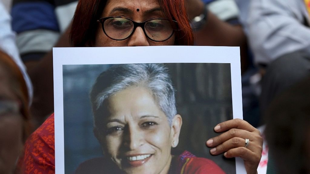 A participant holds a placard with a photograph of journalist Gauri Lankesh at a protest demonstration against her killing.