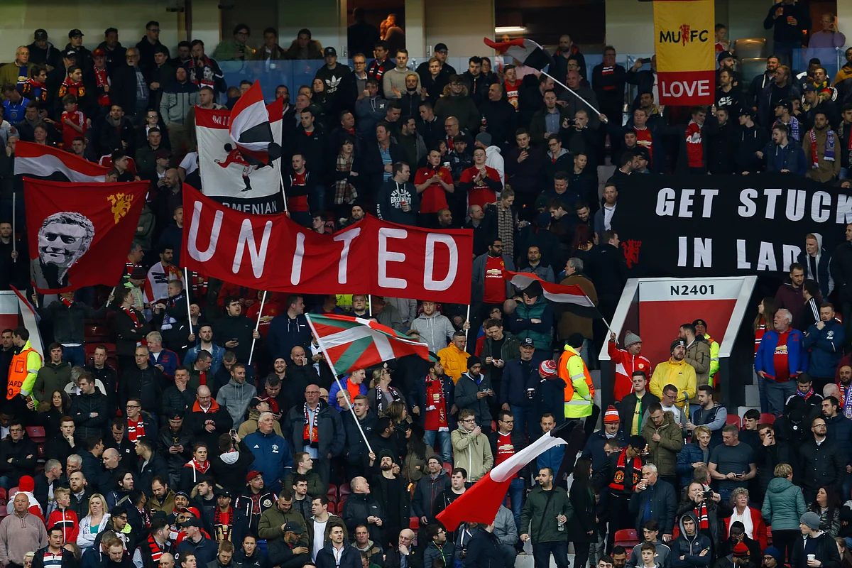 Manchester United fans cheer their team during a match against RSC Anderlecht.