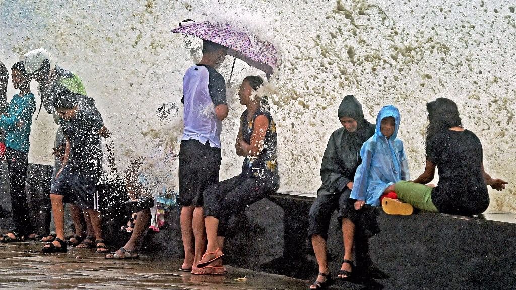 People sit at Worli during high tide. Image used for representational purposes.