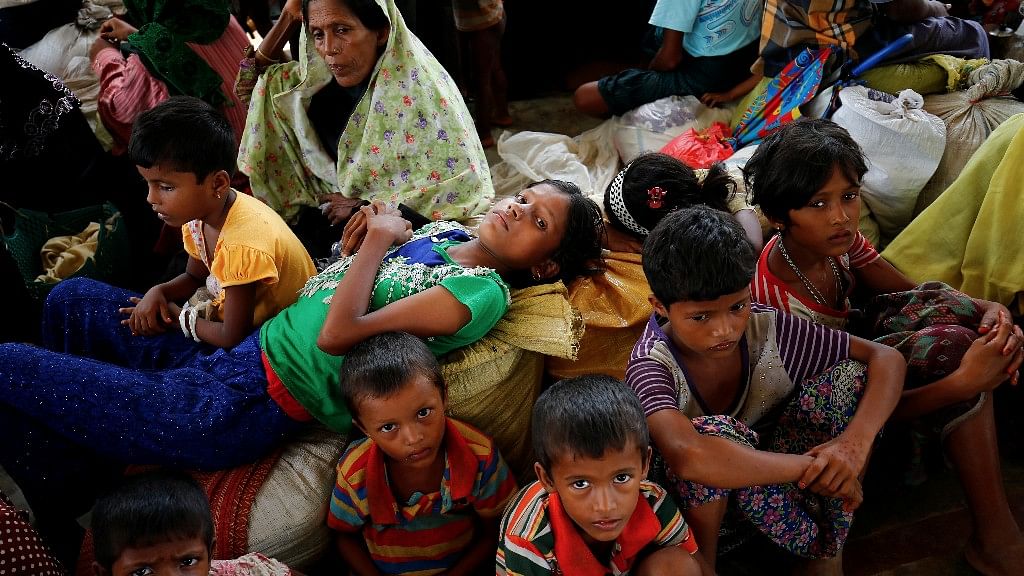 Newly arrived Rohingya refugees sit inside a shelter at the Kutupalang Registered Refugee Camp, in Cox’s Bazar, Bangladesh.