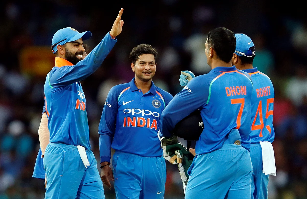 Kuldeep Yadav celebrates a wicket with his teammates.