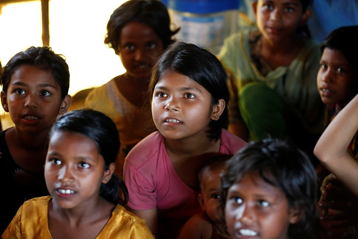 Rohingya refugee children pay attention to the teacher as they attend a session in a makeshift school at Balukhali Makeshift Refugee Camp in Cox’s Bazar, Bangladesh.
