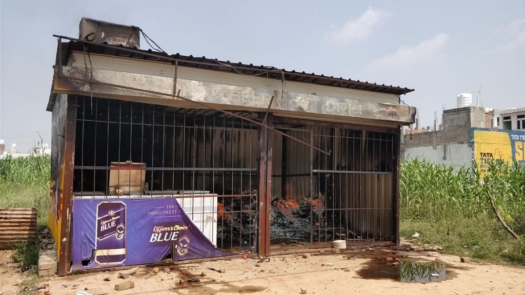 A burnt liquor store in Gurugram on Sunday.