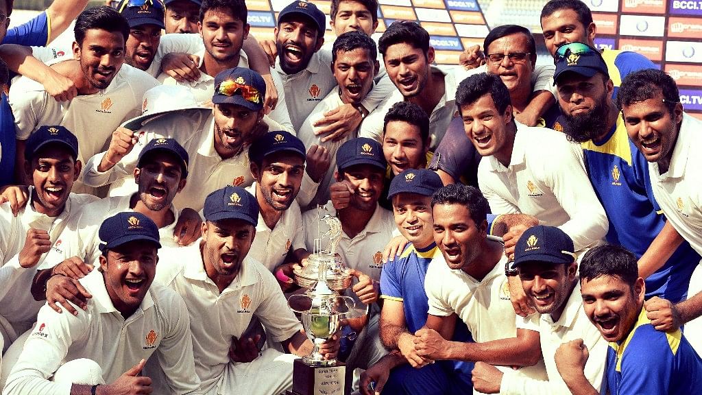 Karnataka players with the winners trophy after the 2014-15 Ranji Trophy season.