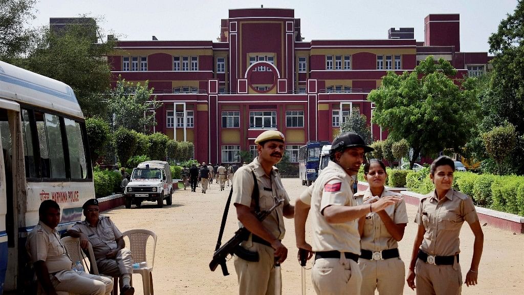 Police stand guard at Ryan International School during a protest, in Gurugram on 9 September.