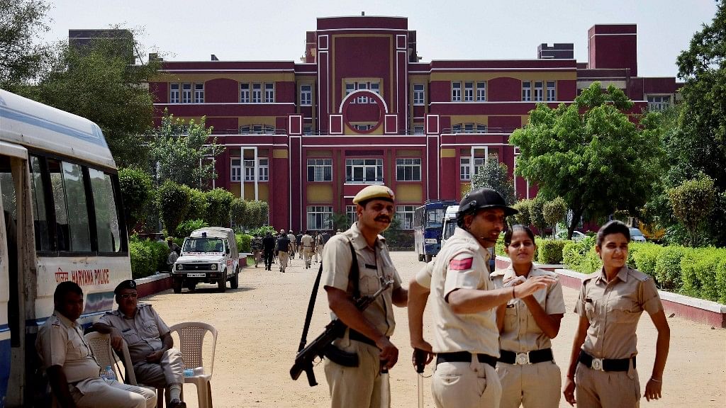 

Police stand guard at Ryan International School during a protest, in Gurugram.