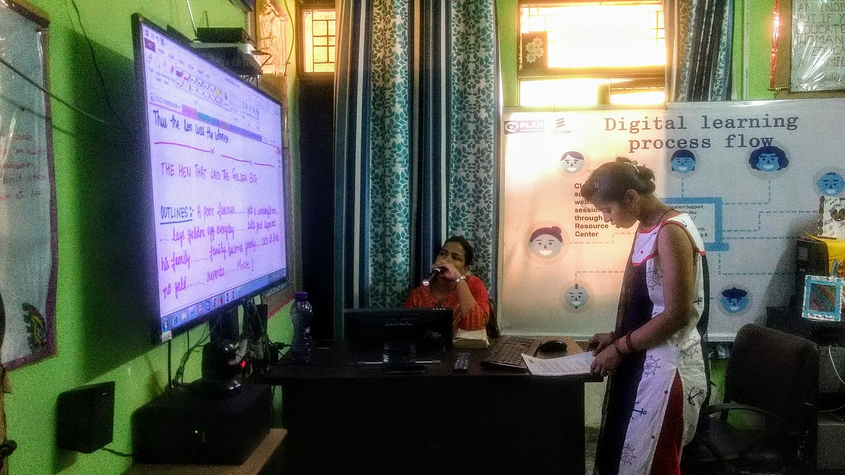 A class in progress. The teacher (pictured seated) is remotely conducting a lesson to students in different centres. 