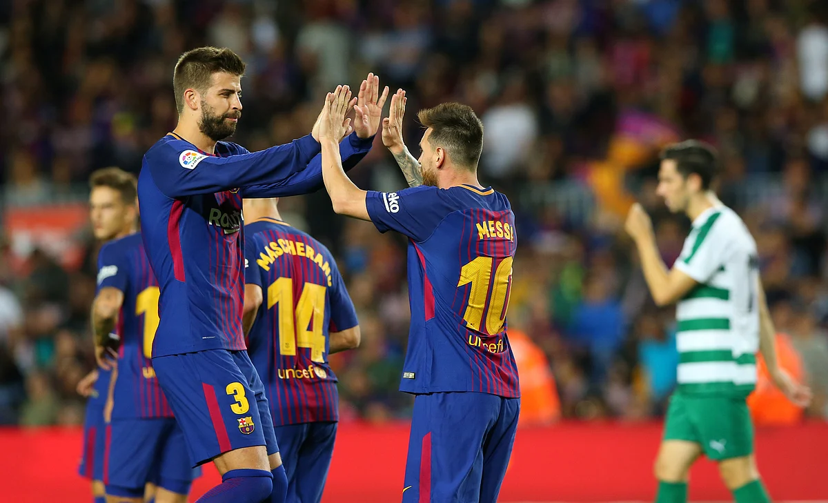 Lionel Messi celebrates a goal with Gerard Pique.