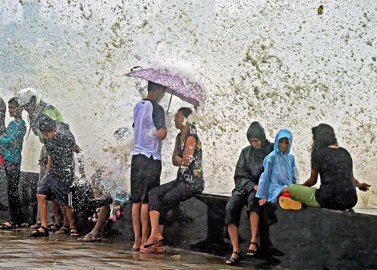 Mumbai: People enjoying the high tide after heavy rains in Mumbai on Wednesday.