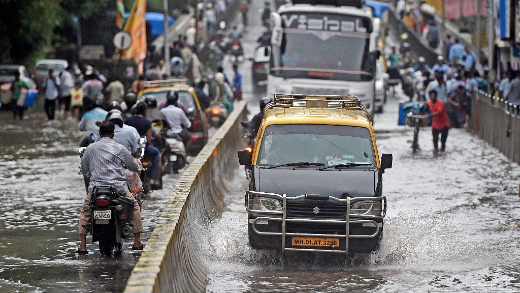 Mumbai woke up to submerged roads and waterlogged tracks, as the city witnessed heavy downpour on Tuesday night, 23 July.