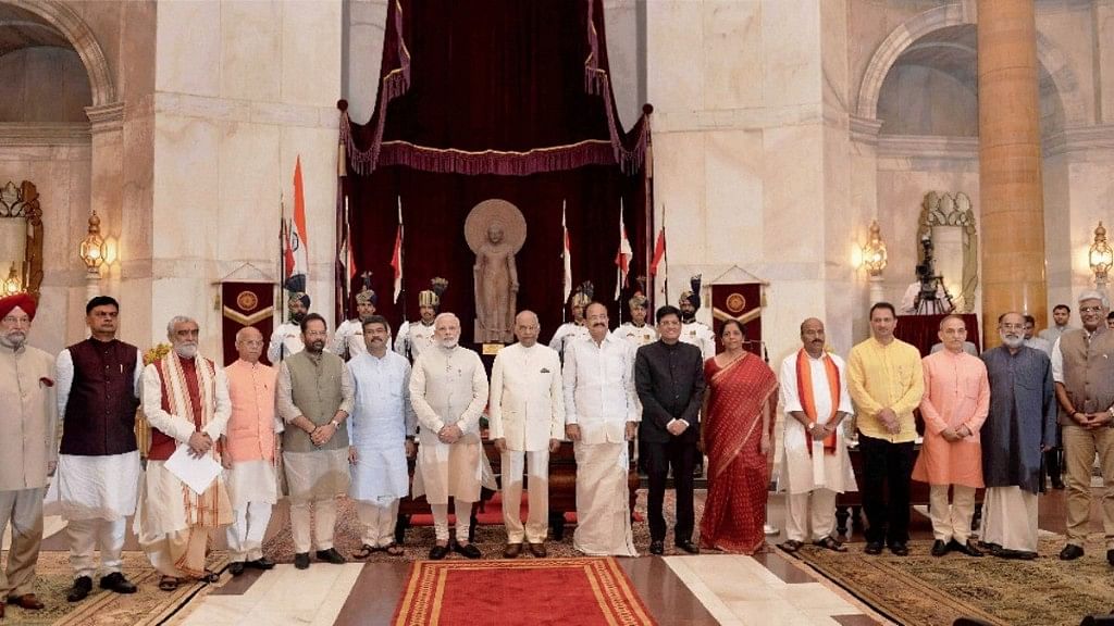Prime Minister Narendra Modi, with the President, Vice President and the new inductees of the cabinet.