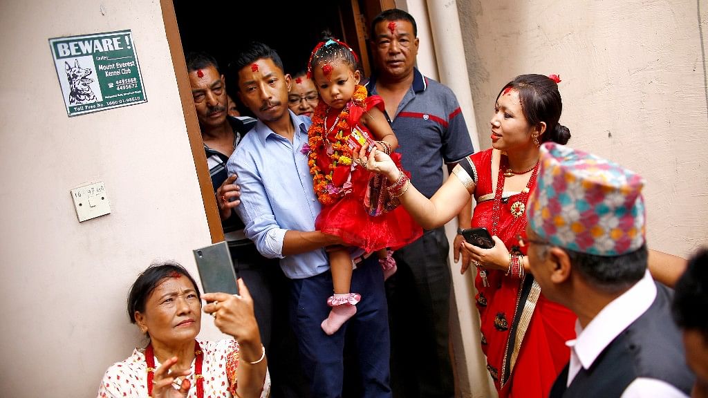 

Nepal’s new living goddess Trishna Shakya is carried by her father as they leave home for a temple palace in Kathmandu.&nbsp;
