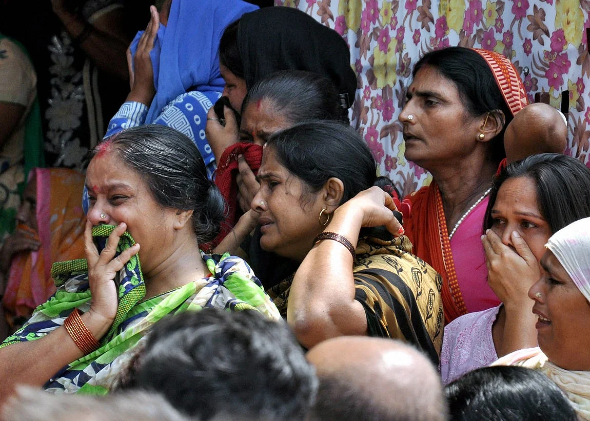 Family members and relatives cry during the funeral of Pradyumn, in Gurugram.