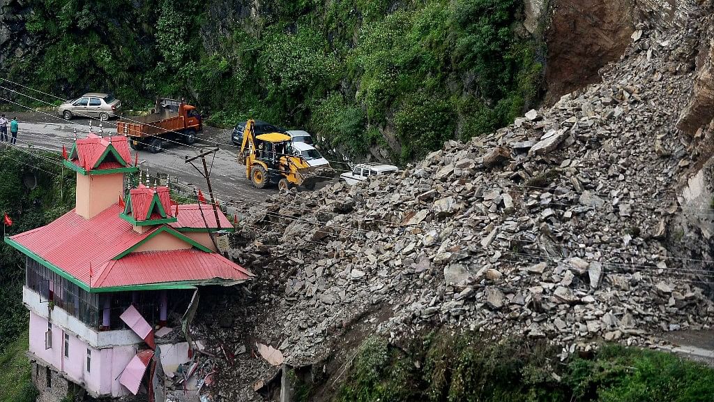 Two-three empty cars are still stuck under the debris from the landslide on the Chandigarh-Shimla National Highway.&nbsp;