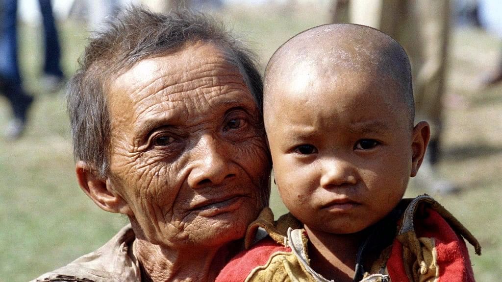 Elderly tribesman Arun Bikash Chakma waits with his grandson on the border of Tripura before retuning to their home in Bangladesh’s Chittagong Hill Tracts.