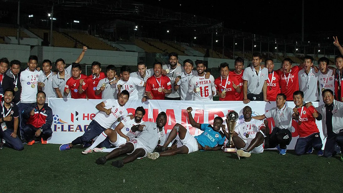 Aizawl FC team celebrate with the I-League trophy.