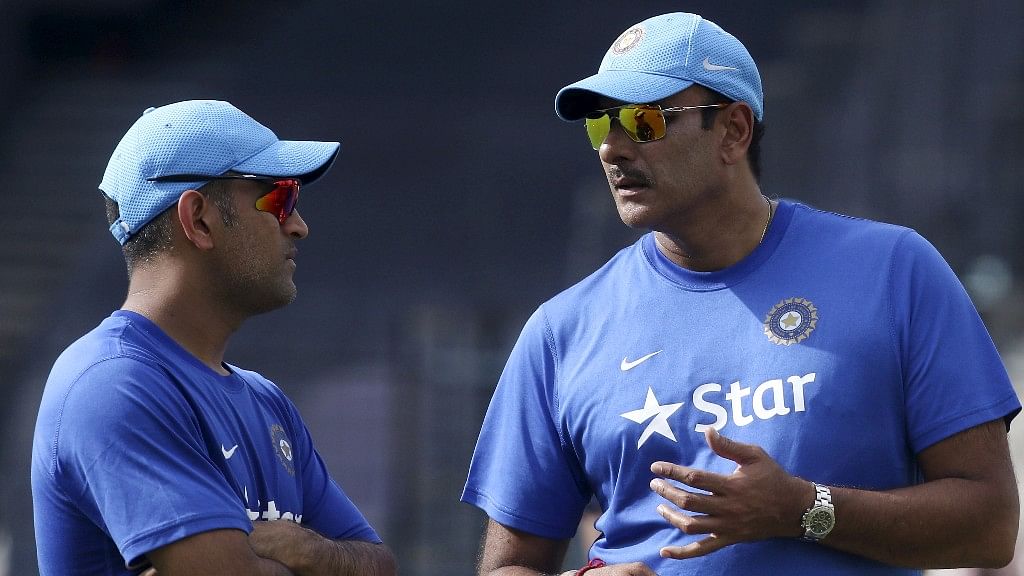 MS Dhoni chats with Ravi Shastri during a practice session.