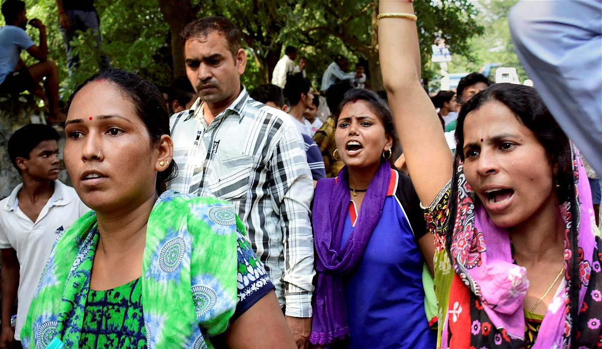Demonstrators raise slogans during a protest outside Ryan International School as they demand action against the school, in Gurugram on Saturday.