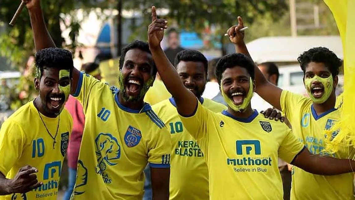 A group of fans cheer for the Kerala Blasters team ahead of an ISL match.