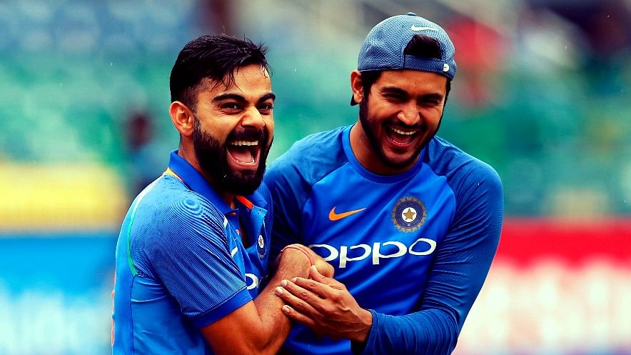 Virat Kohli shares a laughs with Manish Pandey during a training session.