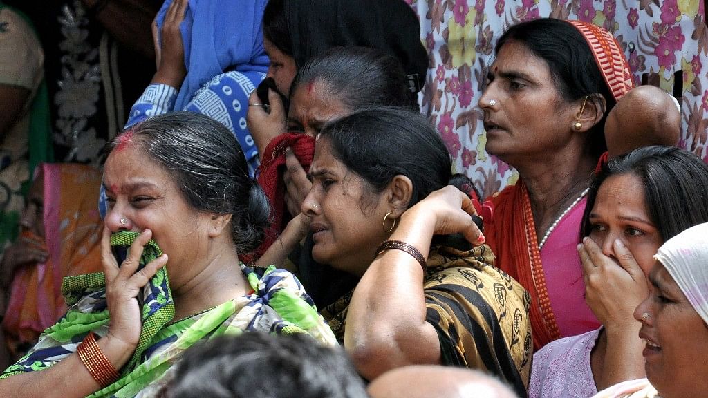 Family members and relatives cry during the funeral of Pradyumn in Gurugram.