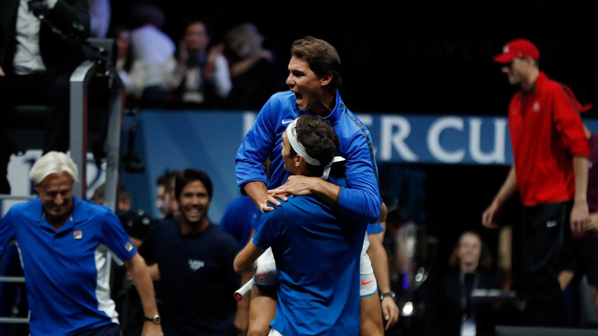 Europe’s Roger Federer celebrates with teammate Rafael Nadal, top center, after defeating World’s Nick Kyrgios during their Laver Cup