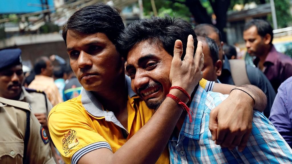 A relative of a stampede victim grieves at a hospital in Mumbai.