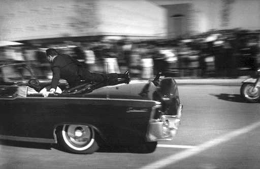 Limousine carrying mortally wounded President John F Kennedy races toward the hospital seconds after he was shot in Dallas.