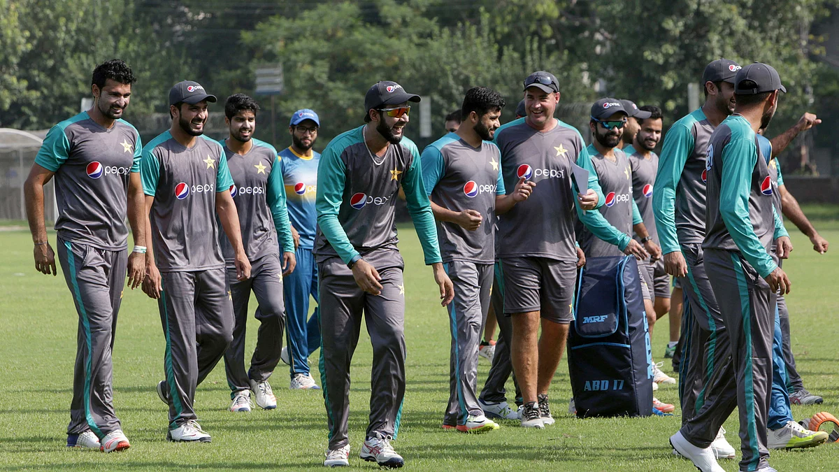 Pakistani cricketer Imad Wasim, centre, shares a joke with teammates, while they attend a training session for the upcoming World XI series at a ground in Lahore, Pakistan, Sunday, Sept. 10, 2017