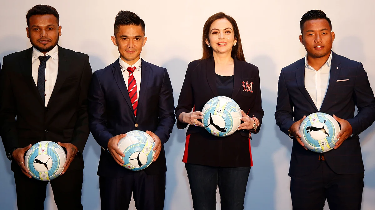Nita Ambani poses for a photograph with Indian football players at the ISL draft in Mumbai on Sunday.