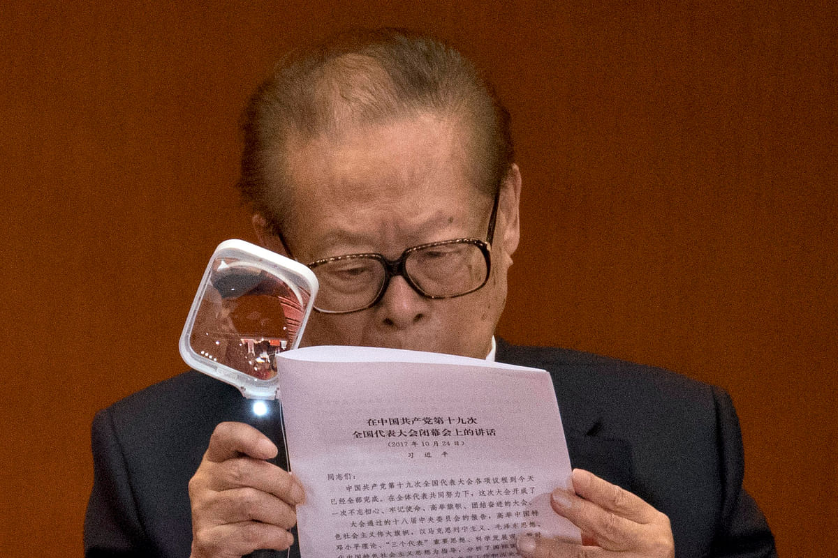 Former Chinese President Jiang Zemin looks at a work report by Chinese President Xi Jinping during the closing ceremony of the 19th Party Congress, Beijing, 24 October, 2017.
